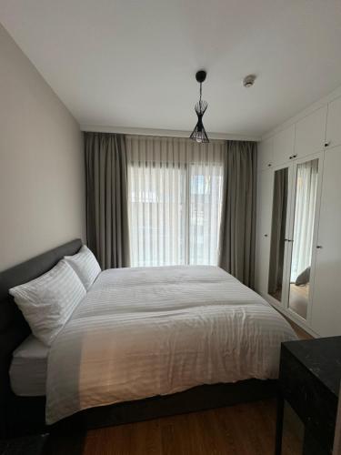 a bedroom with a large bed and a window at Bella Mare Residence Luxury Apartment in Famagusta