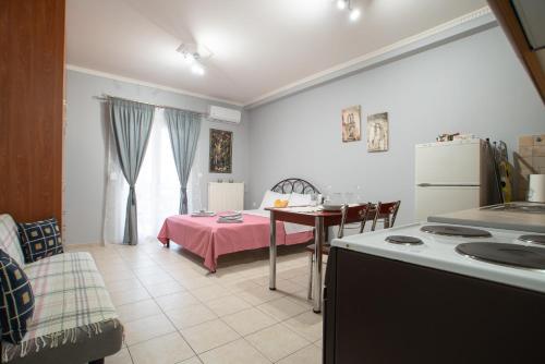 a kitchen with a table and a small kitchen with a tableablish at RIRIKA APARTMENT in Igoumenitsa