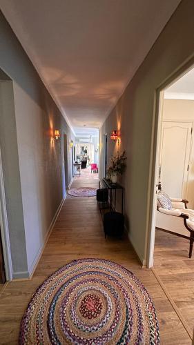 a hallway with a rug on the floor of a house at Bastide Aïna SPA et piscine in Grasse