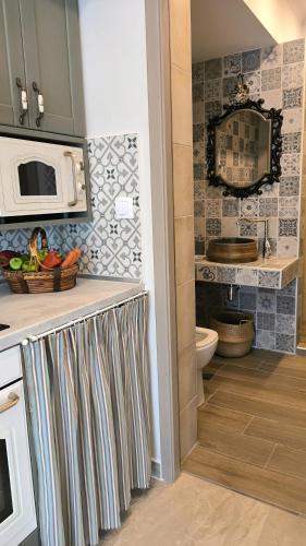 a kitchen with a sink and a microwave at Rizes House II in Agios Nikolaos