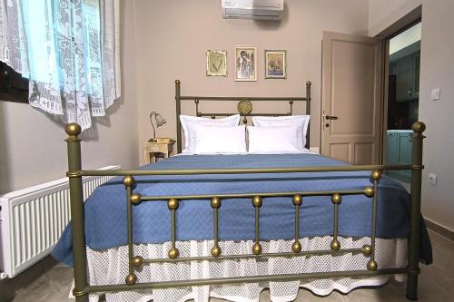 a bedroom with a bed with blue sheets and white pillows at Rizes House II in Agios Nikolaos