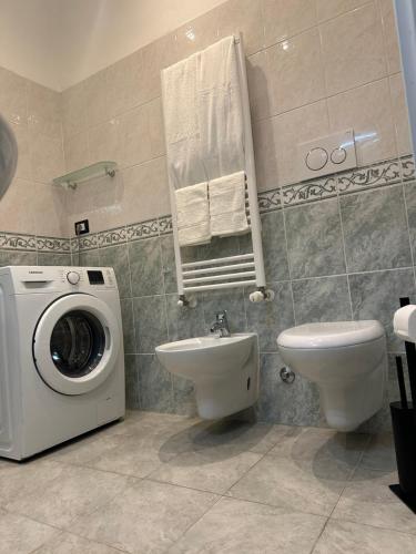 a bathroom with a washing machine and a toilet at Isola Apartment in Milan