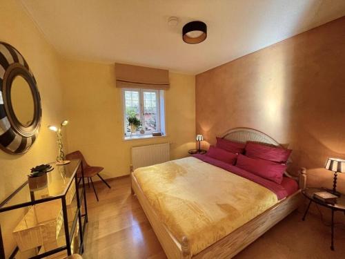 a bedroom with a large bed with red pillows at UNEXPECTED-Bochum in Bochum