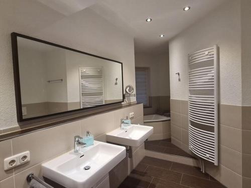 a bathroom with two sinks and a large mirror at Plush apartment in Annaberg-Buchholz in Annaberg-Buchholz