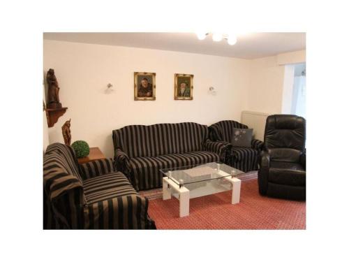 a living room with two couches and a coffee table at Holiday apartment Schlossblick 2 in Zwingenberg