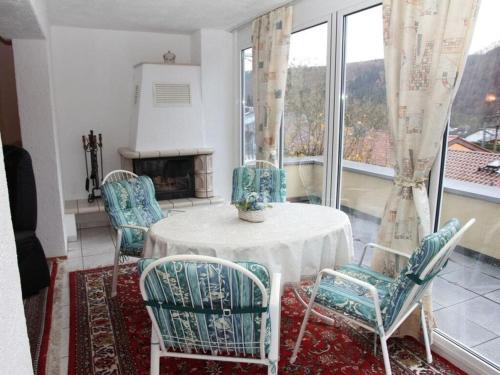 a room with a table and chairs and a fireplace at Holiday apartment Schlossblick 2 in Zwingenberg