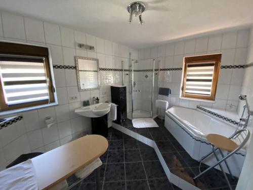 a bathroom with a tub and a sink and a tub and a bath tub at Apartment in Zwingenberg in Zwingenberg