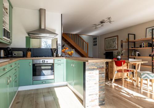 - une cuisine avec des armoires turquoise et un comptoir dans l'établissement La Belle Vue : Duplex avec Terrasse,Jardin,Parking, à Annecy