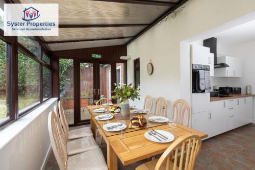 - une salle à manger avec une table et des chaises en bois dans l'établissement Tetuan House - Syster Properties - Work -Family - Groups Leicester LE3, à Leicester