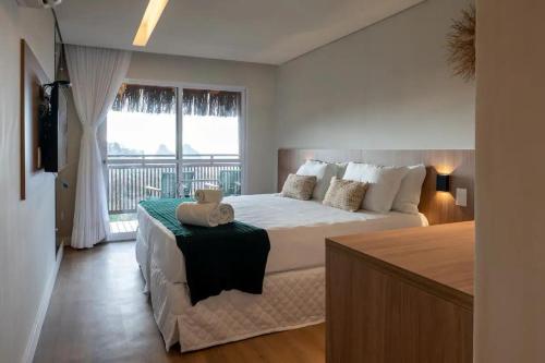 En eller flere senge i et værelse på Pousada Divino Morro