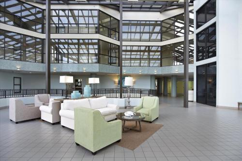 a lobby with couches and chairs in a building at Phoenix 6 Unit 408 in Orange Beach
