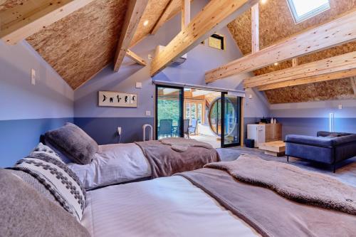 a bedroom with a large bed and wooden ceilings at GRAN TOCORO, RESORT&GLAMPING - Vacation STAY 84990v in Narusawa