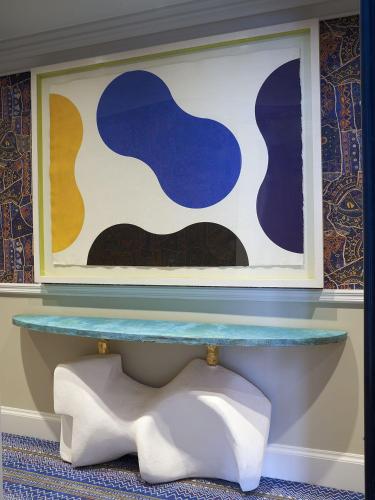 a table in a room with a painting on the wall at Warren Street Hotel in New York