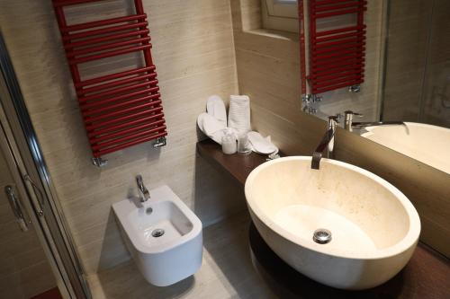 a bathroom with a white sink and a mirror at Terrazza Romanelli Suites in Bitonto