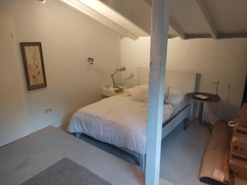a small bedroom with a bed and a table at Künstlerhaus in Überlingen
