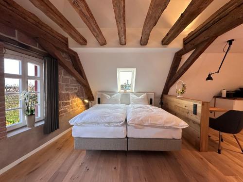 a bedroom with a large bed in a attic at Zum Tausendsassa in Edesheim