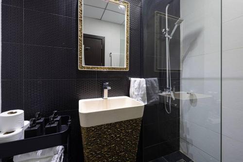 a bathroom with a sink and a mirror at Dubai Sleek & Cozy Space in Dubai