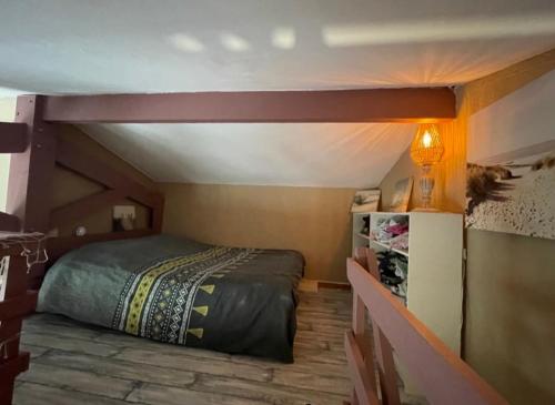 a bedroom with a bed in a small room at Appartement Saint Pierre la mer vue Mer in Fleury