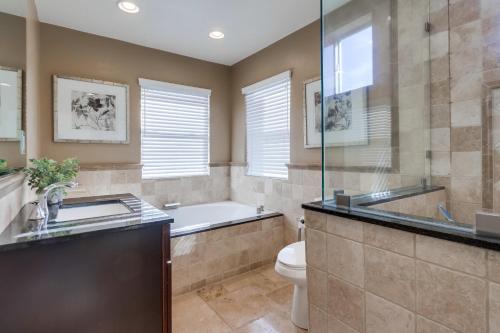 a bathroom with a tub and a toilet and a sink at Destination #48 in Placentia