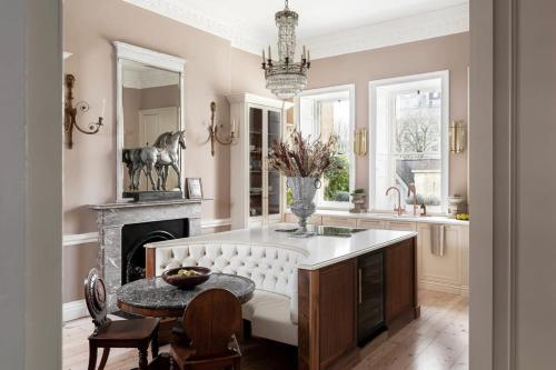 a kitchen with a table and a fireplace at Former Prime Minister's Home in Bath