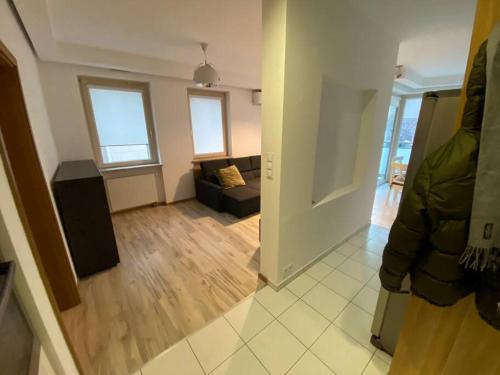 a view of a living room with a couch at Spacious apartment, Metro Gdańsk, Zoliborz in Warsaw