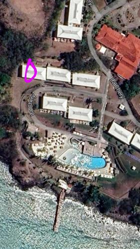 an aerial view of a resort with a pool at Un petit joyau in Le Diamant
