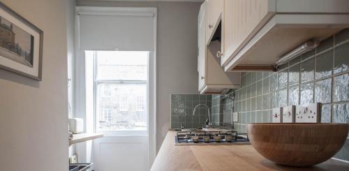 a kitchen with a wooden counter top and a window at Traditional Studio Apartment in Fitzrovia near Oxford Street in London