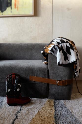 a bag sitting on the floor next to a couch at Yellowstone Peaks Hotel in Island Park