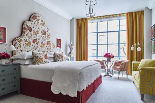 a bedroom with a large bed with a large window at Warren Street Hotel in New York