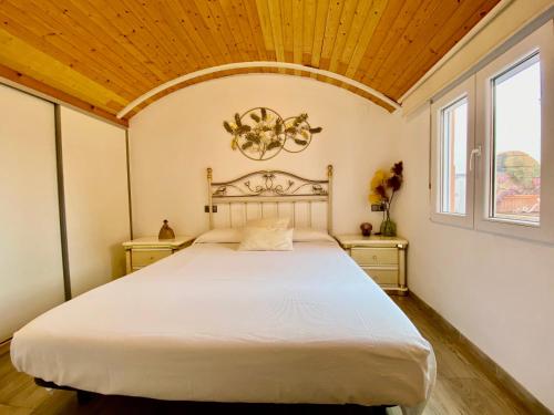 a bedroom with a large bed with a wooden ceiling at Casa en el MAR in Benicarló