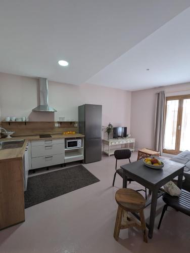 a kitchen and living room with a table and a couch at Mina32 by 7Escalones in Rota
