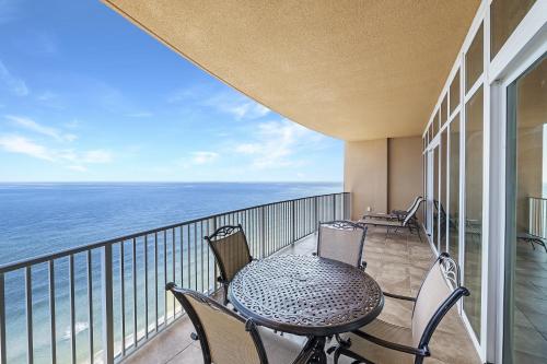 a balcony with a table and chairs and the ocean at Phoenix Gulf Shores Unit 1702 in Gulf Shores