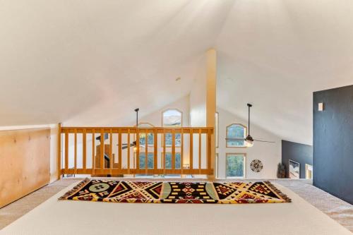 a large room with a rug on the floor at St Mary's Glacier Retreat w Hot Tub & Views in Idaho Springs