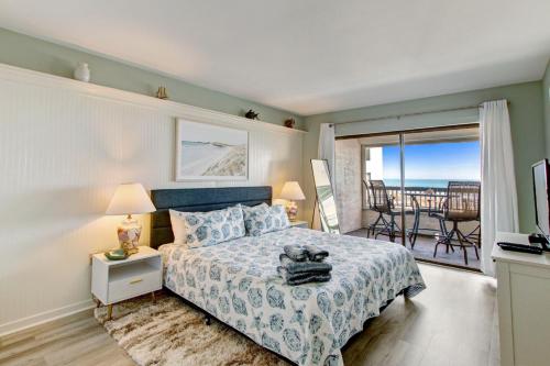 a bedroom with a bed with a view of the ocean at B162 Surf & Racquet - 1BR at Amelia Surf & Racquet Club next to The Ritz! in Amelia Island
