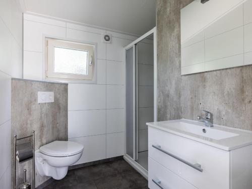 A bathroom at Comfortable chalet with combination microwave near the Veluwe