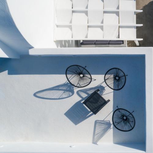 a table with two wheels and a laptop on it at MyBozer Twin Villas Heated Private pools All Year in Foinikiá