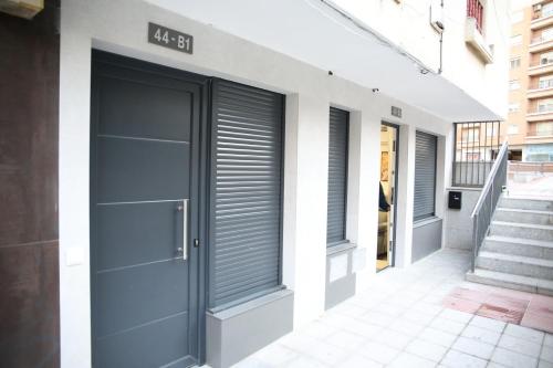 a facade of a building with grey garage doors at E&R-1 Plaza España in Salamanca