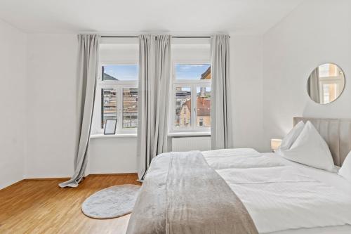 a bedroom with a bed and a large window at FarawayHomes Studio Leoben #K7 in Donawitz