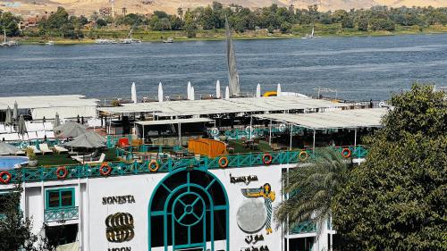 a building next to a body of water at Relaxation, fresh air, and a direct view of the Nile in Naj‘ al ‘Amrāb