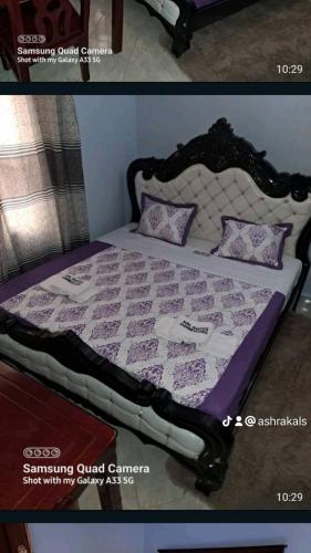 a bed with a purple and white quilt on it at Kal Era Suites in Mbarara