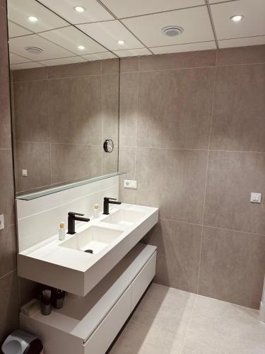 a bathroom with a white sink and a mirror at Beach House Jávea - Penthouse with Private Rooftop Terrace in Jávea