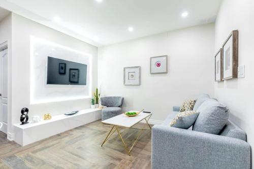 a living room with a couch and a table at Modern Pet-friendly Chinatown Apartment in Toronto