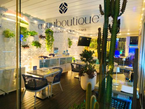 a store front with a table and chairs and plants at Aquaboutique Wellness&Spa in Vietri sul Mare