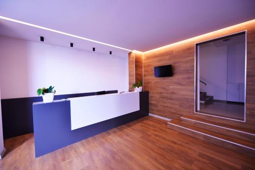 a lobby with a reception desk and a large window at Aparthotel Miramare in Sarandë