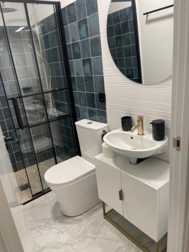 a bathroom with a toilet and a sink and a mirror at Castillo Principal in Almansa