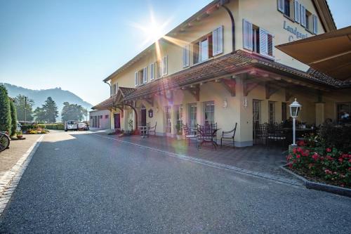 a building with tables and chairs on a street at Camping Wagenhausen in Wagenhausen