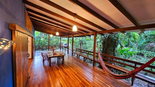 a porch of a house with a table and chairs at Pincoya in Punta Uva