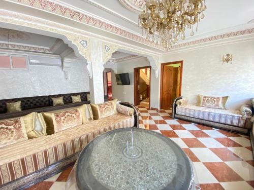 a large living room with couches and a chandelier at Lina confort a tanger in Tangier