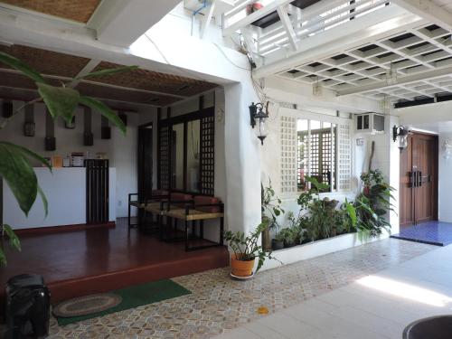 an open room with plants on the walls at Orange Mangrove Pension House by SMS Hospitality in Puerto Princesa City