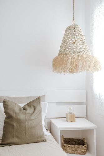 a bedroom with a bed with a pillow and a lamp at Casa da Sereia in Leiria